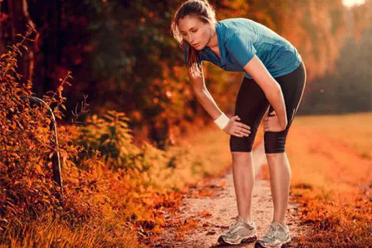 lady taking a break from running in a spring setting outdoors