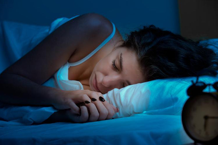 lady in bed resting her head on a pillow