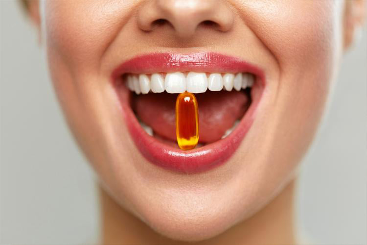 supplement in a ladies mouth